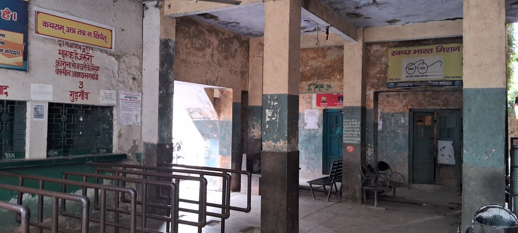 Inside Kotdwar Bus Stand ticket booking area, showing aging infrastructure, waiting benches, and public service counters used by daily commuters in Uttarakhand.