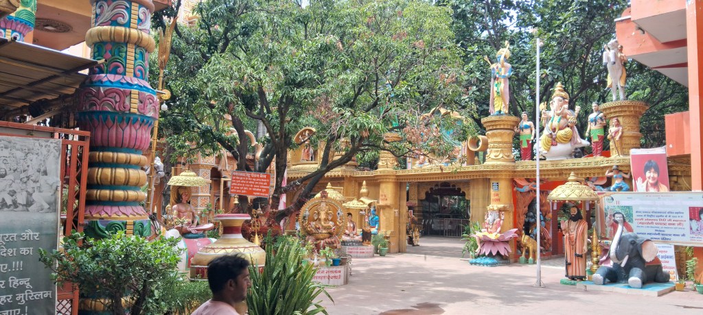 Colourful entrance courtyard of Pilot Baba Ashram in Haridwar with statues of Hindu deities and sages