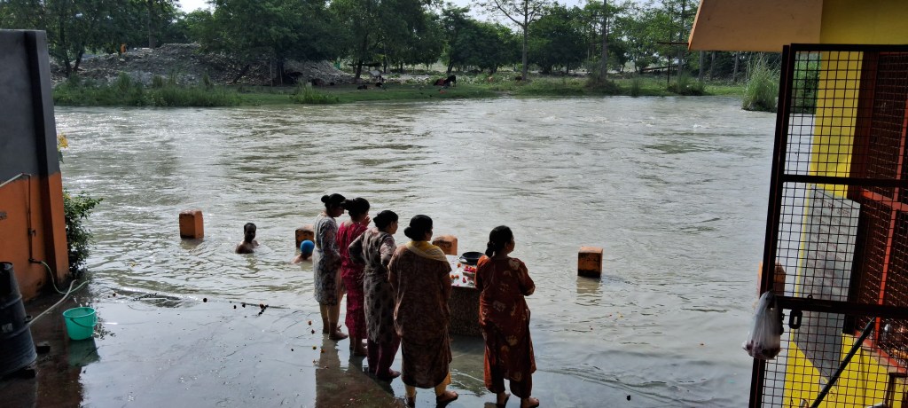 Devotees performing rituals at Shri Harigiri Sanyas Ashram Ghat on the fast-flowing Ganga in Kankhal, Haridwar